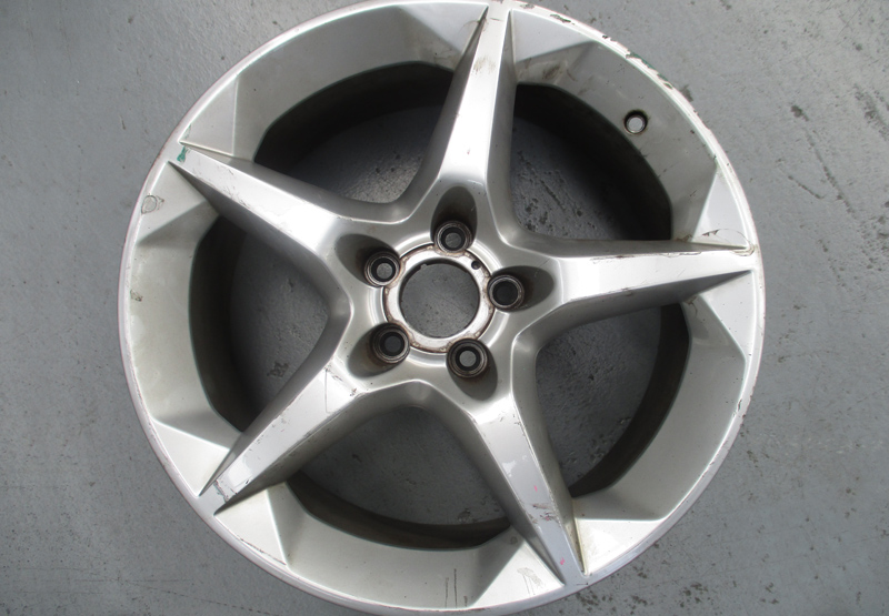 Five-spoke silver wheel — before restoration