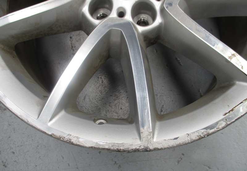 Heavy kerb strike — before restoration