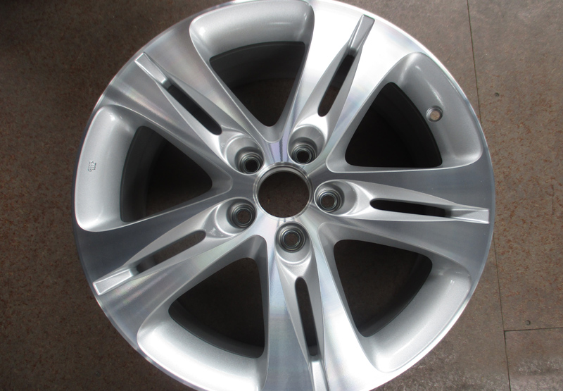 A refinished multi-spoke alloy wheel with a restored machined face